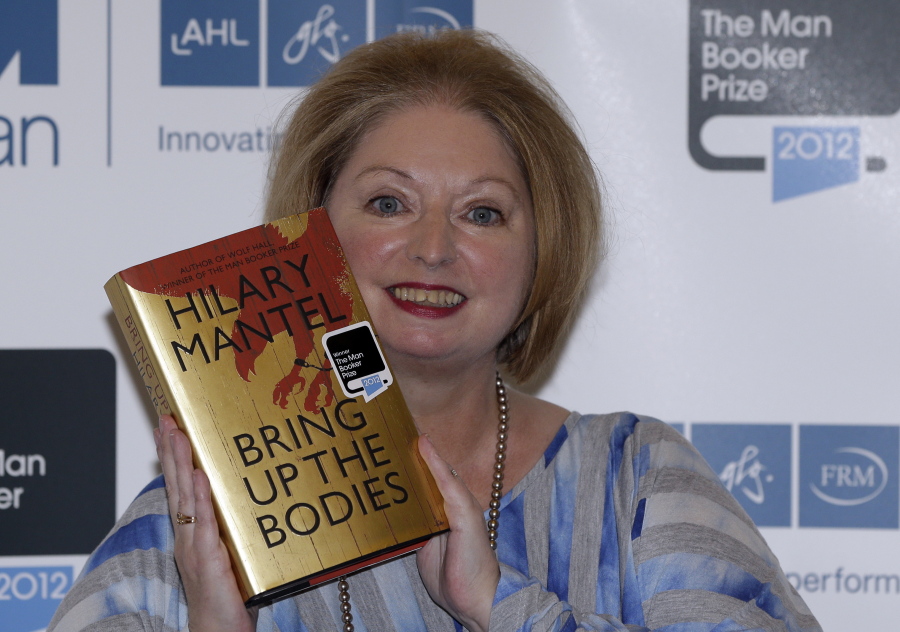 FILE - Hilary Mantel, winner of the Man Booker Prize for Fiction, poses with a copy of her book 'Bring up the Bodies', shortly after the award ceremony in central London, on Oct. 16, 2012. Mantel, the Booker Prize-winning author of the acclaimed "Wolf Hall" saga, has died, publisher HarperCollins said Friday Sept. 23, 2022. She was 70.