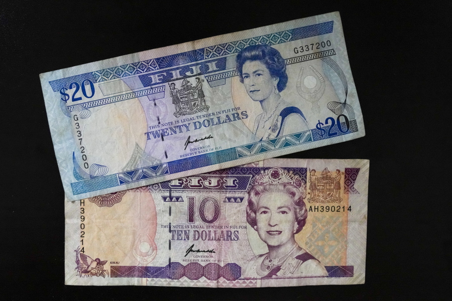 Fiji $10 and $20 bills bills are pictured in Sydney, Saturday, Sept. 10, 2022. As the United Kingdom's reigning monarch, Queen Elizabeth II was depicted on British bank notes and coins for decades. It's less well known that her portrait was featured on currencies in dozens of other places around the world, in a reminder of the British empire's colonial reach.