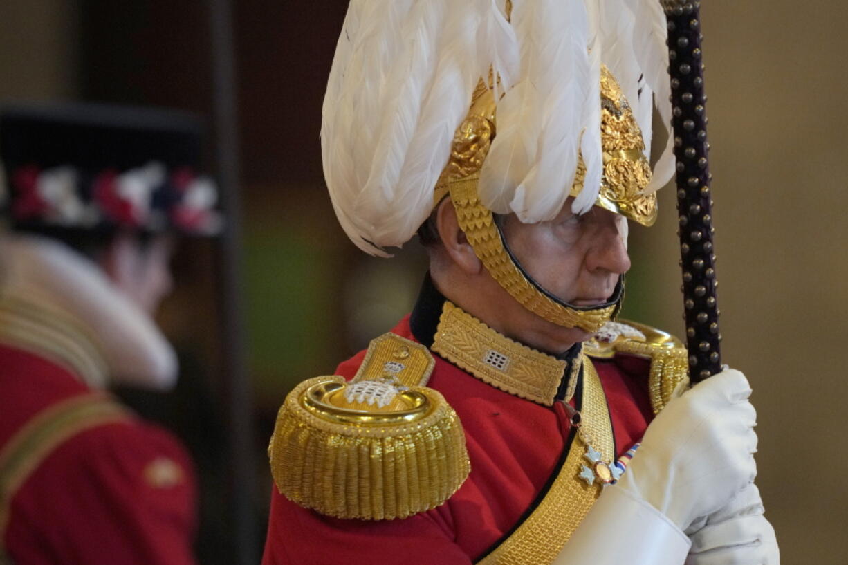 A member of The King's Body Guards of the Honourable Corps of Gentlemen at Arms performs guard duties around the coffin of Queen Elizabeth II, Lying in State inside Westminster Hall, at the Palace of Westminster, in London, Sunday, Sept. 18, 2022, ahead of her funeral on Monday.