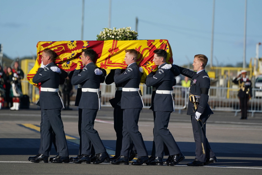 The coffin of Queen Elizabeth II is carried to the RAF aircraft at Edinburgh Airport, Scotland, Tuesday Sept. 13, 2022, for the final journey from Scotland in a Royal Air Force plane to London.