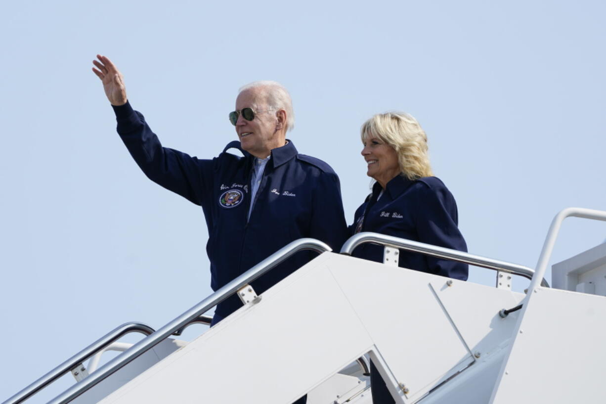 President Joe Biden waves as he stands at the top of the steps of Air Force One before boarding with first lady Jill Biden at Andrews Air Force Base, Md., Saturday, Sept. 17, 2022, as they head to London to attend the funeral for Queen Elizabeth II. To commemorate the U.S. Air Force's 75th Anniversary as a service the Bidens are wearing Air Force One jackets.