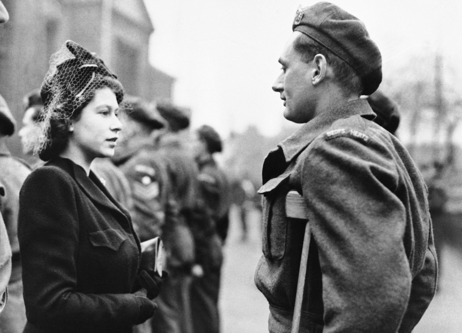 FILE - Princess Elizabeth of England talks to Private Rupert John Worth during a visit to Bedford, England on Feb. 14, 1946.
