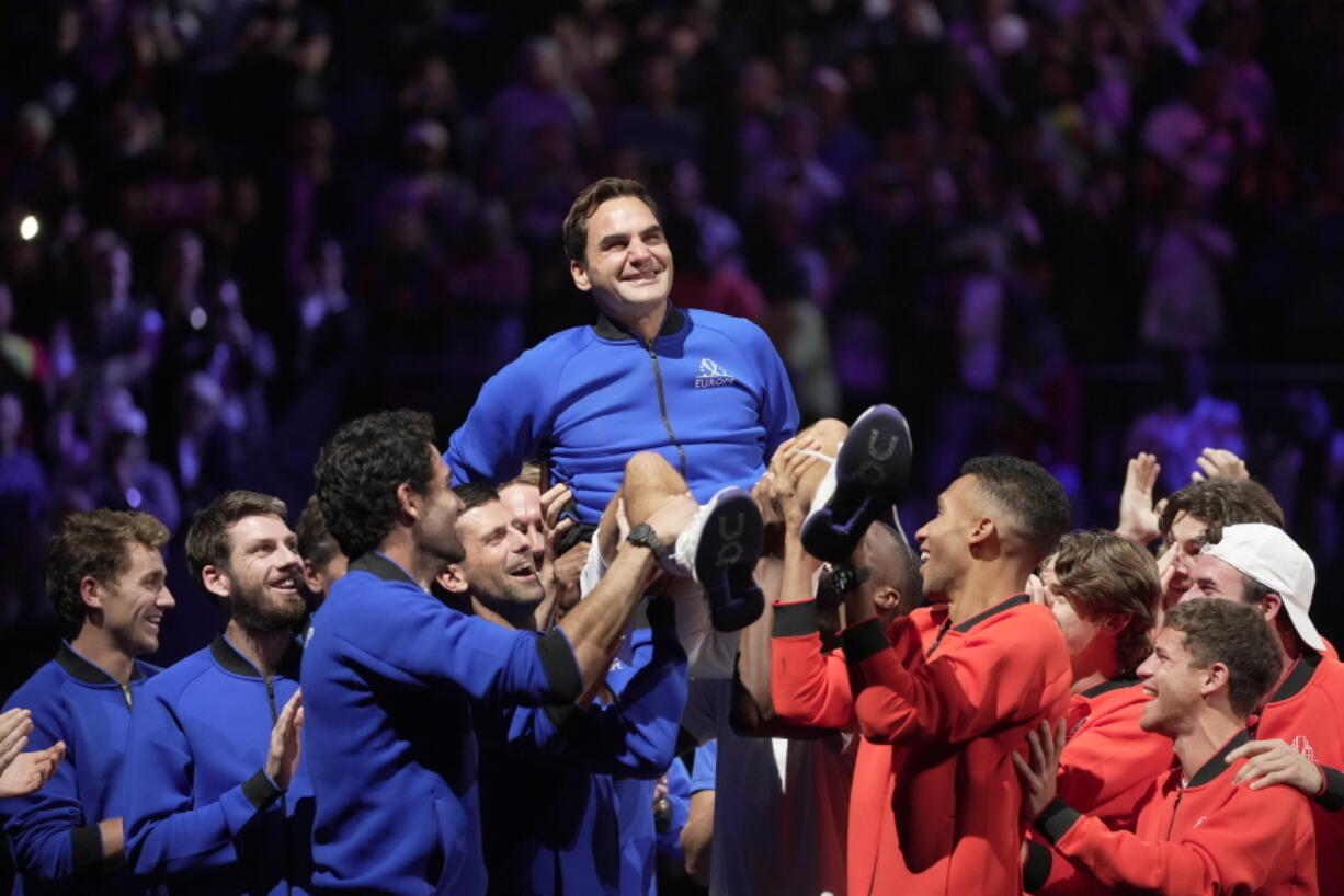 Roger Federer is lifted in celebration by fellow players Friday at the Laver Cup in London after playing the final match of his illustrious tennis career.
