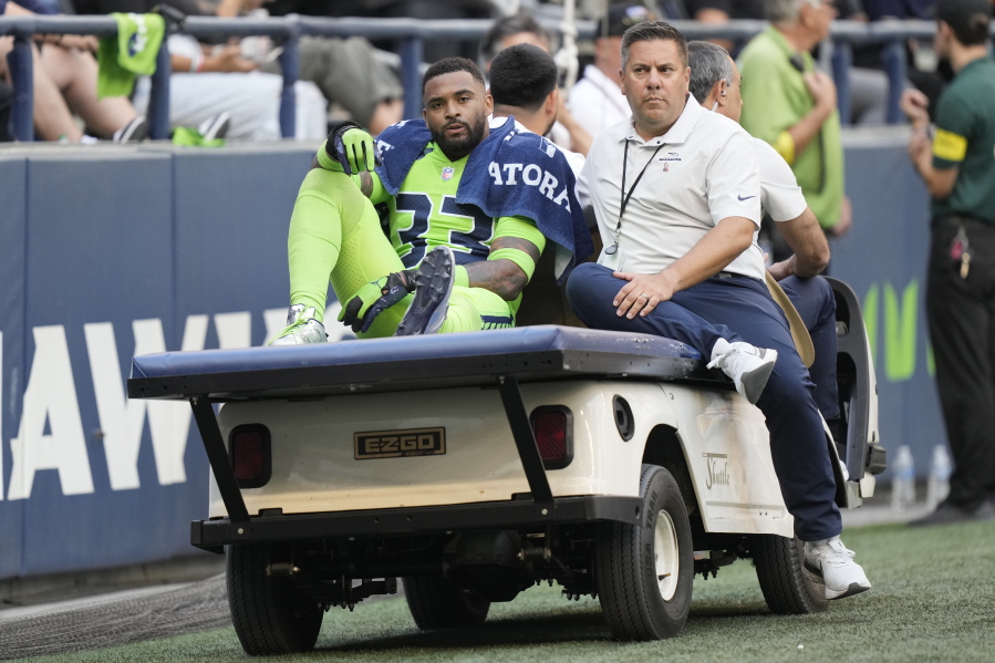 Seattle Seahawks safety Jamal Adams is taken off the field on a cart after an injury during the first half of an NFL football game against the Denver Broncos, Monday, Sept. 12, 2022, in Seattle.