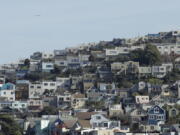 FILE - A plane flies over homes and residential buildings in San Francisco, Wednesday, March 4, 2020. California lawmakers have reached a deal on a pair of housing production bills. The bills would open up much of the state's commercial land for residential development. California has a housing shortage.