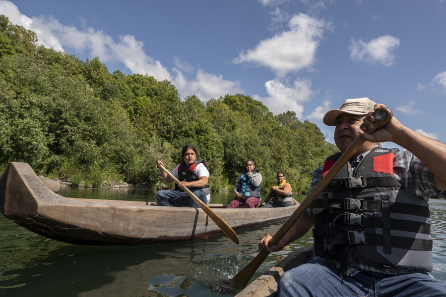 FILE - Yurok tribal members lead a redwood canoe tour on the lower Klamath River on Tuesday, June 8, 2021, in Klamath, Calif. California officials and tribal leaders announced the Visit Native California initiative to drive up tourism in Native communities, Wednesday, Sept. 14, 2022. The canoe tours, in traditionally-made canoes, are among the many cultural experiences visitors can find throughout the state.