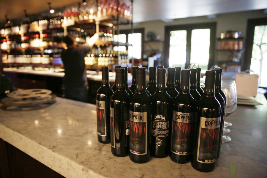 FILE - Bottles of Apocalypse Now Red Blend wine stand on a tasting bar counter at the Francis Ford Coppola Winery, May 21, 2020, in Geyserville, Calif. California will add wine and liquor bottles to its recycling rebate program under a law taking effect in July 2024. Senate President Pro Tempore Toni Atkins said Wednesday, Sept. 28, 2022, that the state's recycling program has needed fixing for decades.