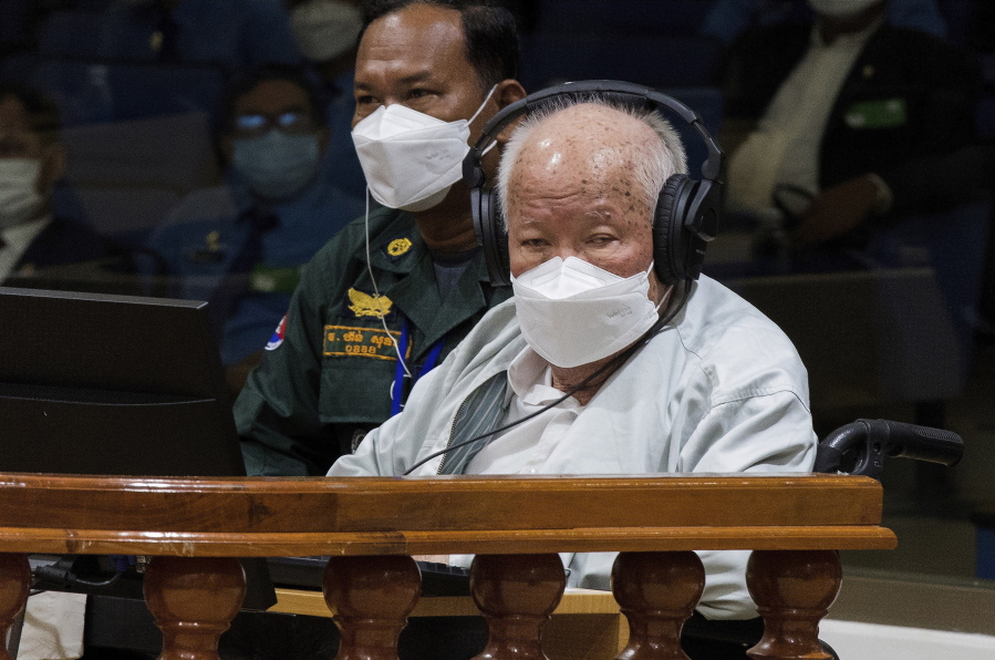 In this photo released by the Extraordinary Chambers in the Courts of Cambodia, Khieu Samphan, right, the former head of state for the Khmer Rouge, sits in a courtroom during a hearing at the U.N.-backed war crimes tribunal in Phnom Penh, Cambodia, Thursday, Sept. 22, 2022. The international court convened in Cambodia to judge the brutalities of the Khmer Rouge regime that caused the deaths of an estimated 1.7 million people in the 1970s ends its work Thursday after spending $337 million and 16 years to convict just three men of crimes.