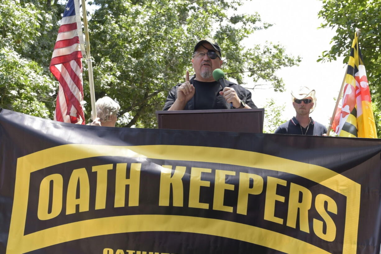 FILE - Stewart Rhodes, founder of the Oath Keepers, center, speaks during a rally outside the White House in Washington, June 25, 2017. Hundreds of pages of court documents in the case against Rhodes and four co-defendants, whose trial opens with jury selection Tuesday, Sept. 27, 2022, in Washington's federal court, paint a picture of a group so determined to overturn Biden's election that some members were prepared to lose their lives to do so.