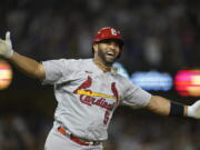 St. Louis Cardinals designated hitter Albert Pujols (5) watches after hitting a home run during the fourth inning of a baseball game against the Los Angeles Dodgers in Los Angeles, Friday, Sept. 23, 2022. Brendan Donovan and Tommy Edman also scored. It was Pujols' 700th career home run.