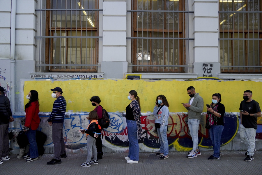 People line up to vote in a plebiscite on a new draft of the Constitution in Santiago, Chile, Sunday, Sept. 4, 2022. Chileans are deciding if they will replace the current Magna Carta imposed by a military dictatorship 41 years ago.