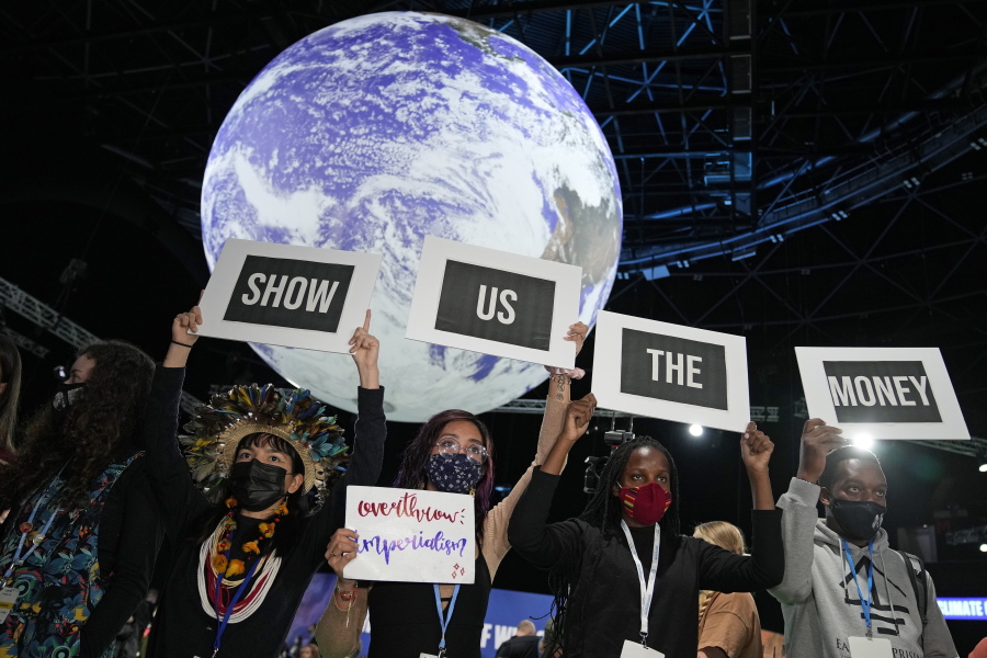 FILE - Climate activist Vanessa Nakate, second right, and other activists engage in a 'Show US The Money' protest at the COP26 U.N. Climate Summit in Glasgow, Scotland, Nov. 8, 2021. From drought to cyclones and sea level rise, the cost of damage caused by climate change in Africa will only get higher as the world warms, stirring concerns from activists and officials about how to pay for it.