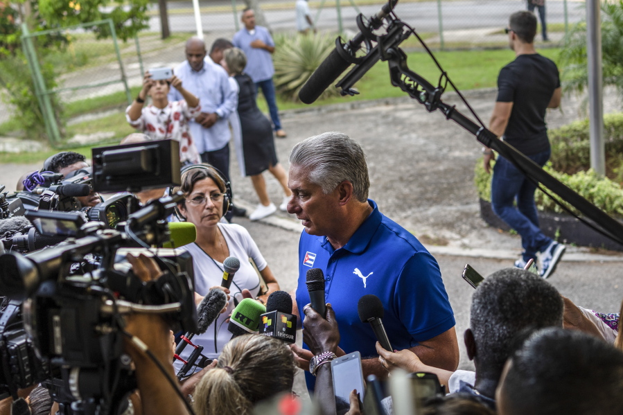 Cuba's President Miguel Diaz Canel speaks to the press after casting his vote at a polling station during the new Family Code referendum in Havana, Cuba, Sunday, Sept. 25, 2022. The draft of the new Family Code, which has more than 480 articles, was drawn up by a team of 30 experts, and it is expected to replace the current one that dates from 1975 and has been overtaken by new family structures and social changes.