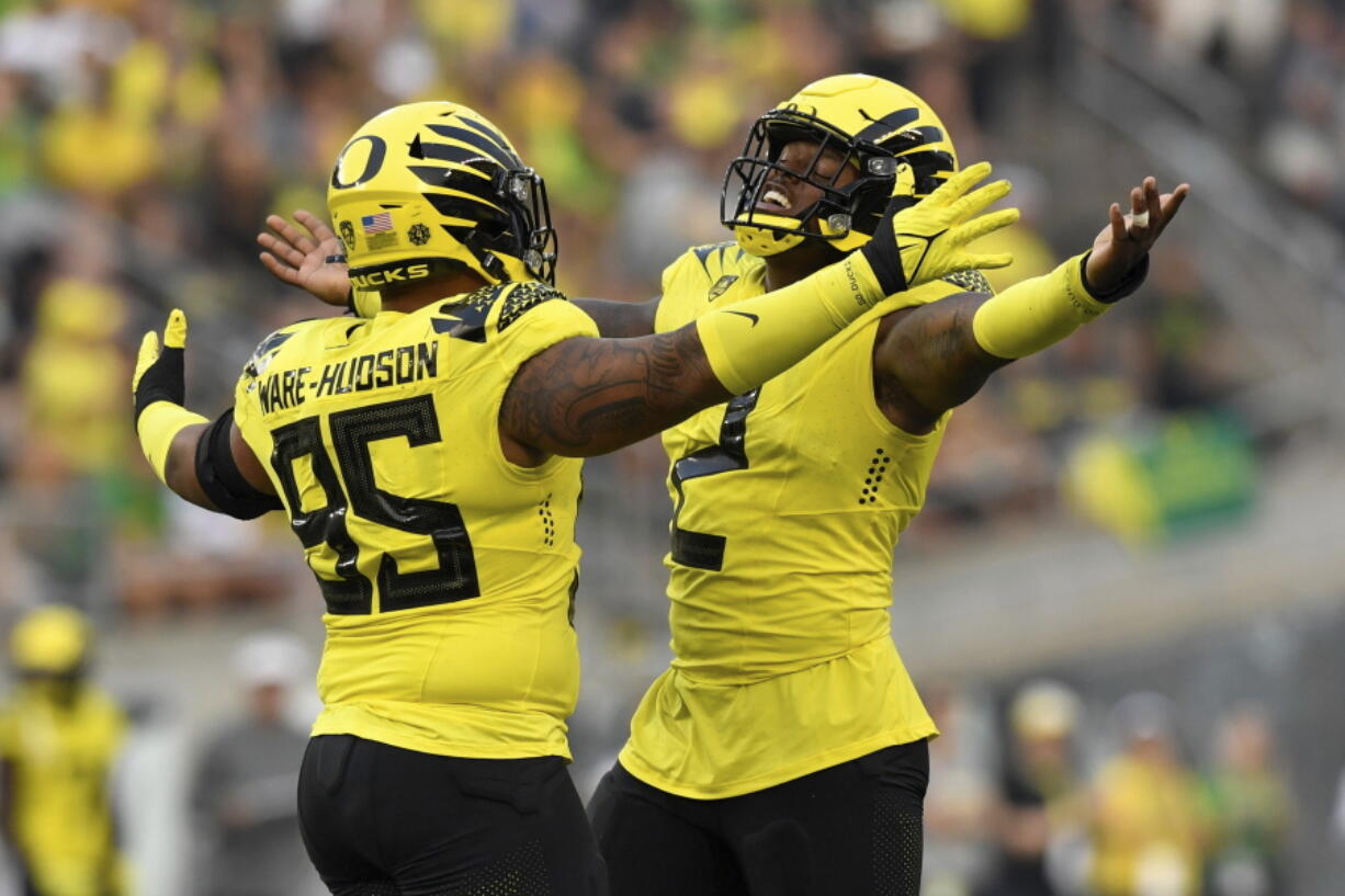Oregon defensive tackle Keyon Ware-Hudson (95) and linebacker DJ Johnson (2) celebrate a sack against Eastern Washington during the second quarter of an NCAA college football game Saturday, Sept. 10, 2022, in Eugene, Ore.