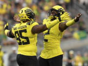 Oregon defensive tackle Keyon Ware-Hudson (95) and linebacker DJ Johnson (2) celebrate a sack against Eastern Washington during the second quarter of an NCAA college football game Saturday, Sept. 10, 2022, in Eugene, Ore.