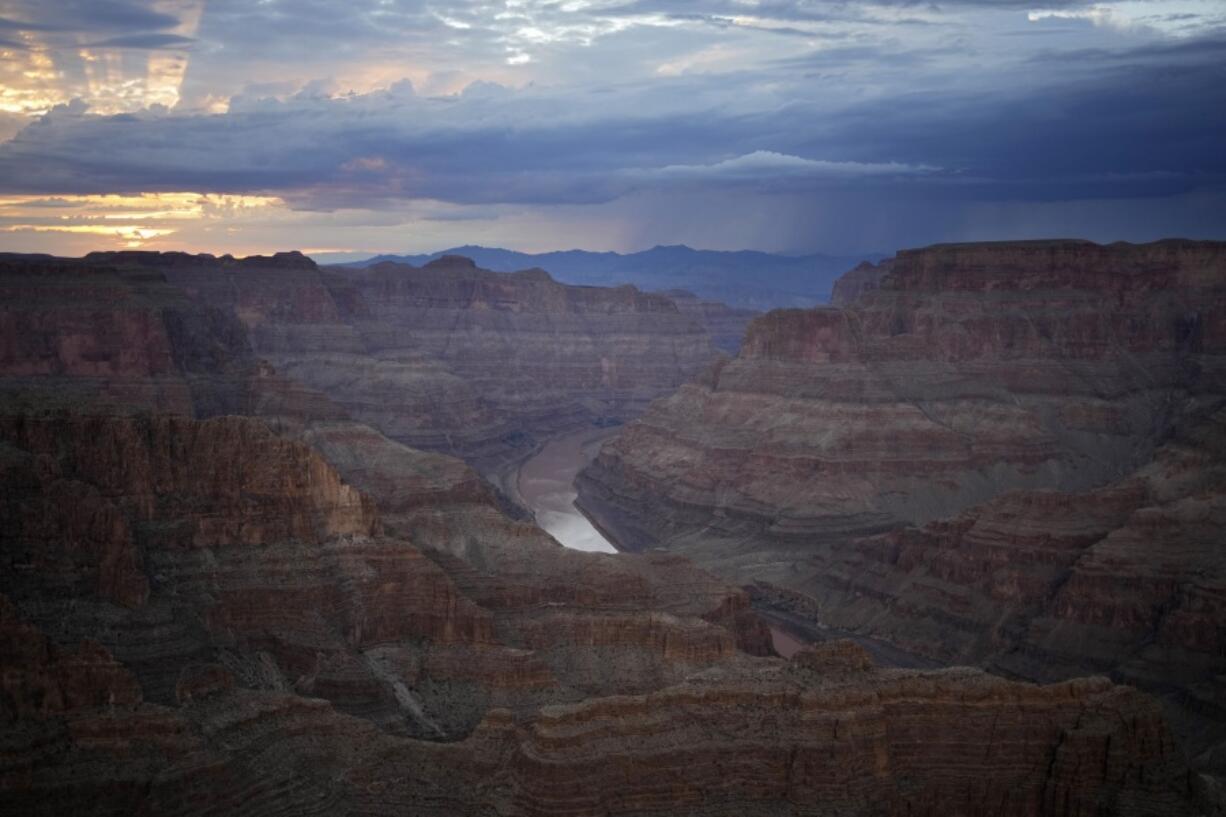 FILE - The Colorado River flows through the Grand Canyon on the Hualapai reservation on Aug. 15, 2022, in northwestern Arizona. The consequences of drought and efforts to funnel billions of dollars toward securing water supplies in the West are becoming larger issues in two of the most consequential races for the U.S. Senate. In Nevada and Arizona, cities and farmers are facing cuts as the Colorado River dwindles.
