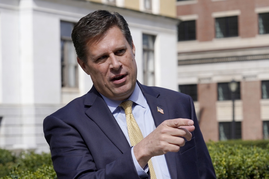 FILE - Republican gubernatorial candidate Geoff Diehl speaks to reporters outside the Statehouse, in Boston, March 21, 2022. Diehl, who has former President Donald Trump's endorsement, is going up against businessman Chris Doughty, a political newcomer, in the Republican primary for governor on Tuesday, Sept. 6.