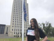 Former Miss America Cara Mund poses in front of the North Dakota state Capitol in Bismarck, N.D., Saturday, Sept. 17, 2022. Mund is running as an independent candidate for North Dakota's lone U.S. House seat.