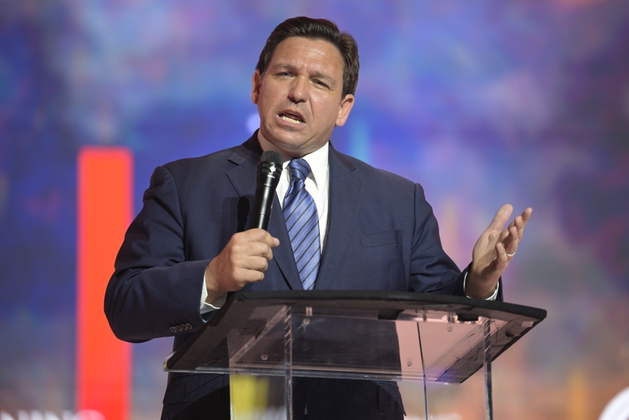FILE - Florida's Republican Gov. Ron DeSantis addresses attendees during the Turning Point USA Student Action Summit, Friday, July 22, 2022, in Tampa, Fla. DeSantis' effort to place candidates fully aligned with his conservative views on school boards throughout the state is helping him expand his influence. Of the 30 candidates endorsed by DeSantis in the Aug. 23 elections, 19 won, five lost and six are headed to runoffs. (AP Photo/Phelan M.