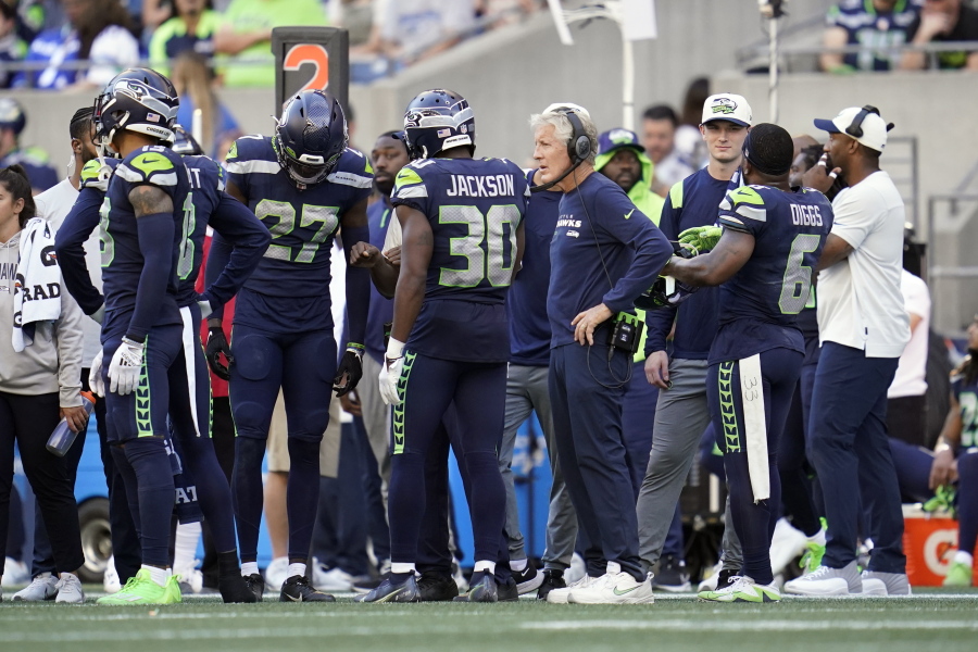 Seattle Seahawks head coach Pete Carroll, center right, looks on as players are asked to vacate the field as part of a security timeout during the second half of an NFL football game against the Atlanta Falcons, Sunday, Sept. 25, 2022, in Seattle.