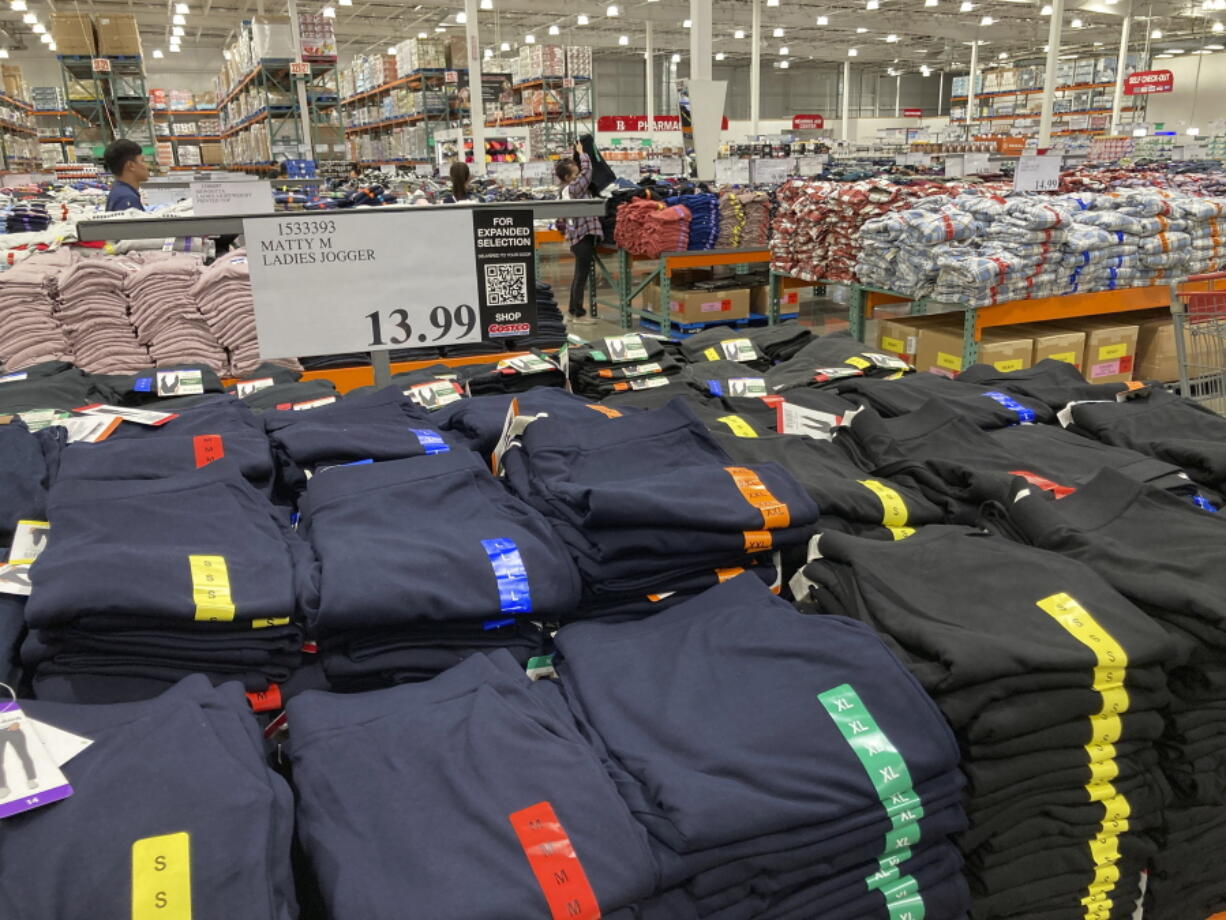 FILE - Clothing sits on tables for shoppers in a Costco warehouse Monday, Aug. 29, 2022, in Sheridan, Colo. The Federal Reserve is expected to raise its key short-term rate by a substantial three-quarters of a point for the third consecutive time Wednesday, Sept. 21. The goal is to slow consumer spending, reducing demand for homes, cars and other goods and services, eventually cooling the economy and lowering prices.