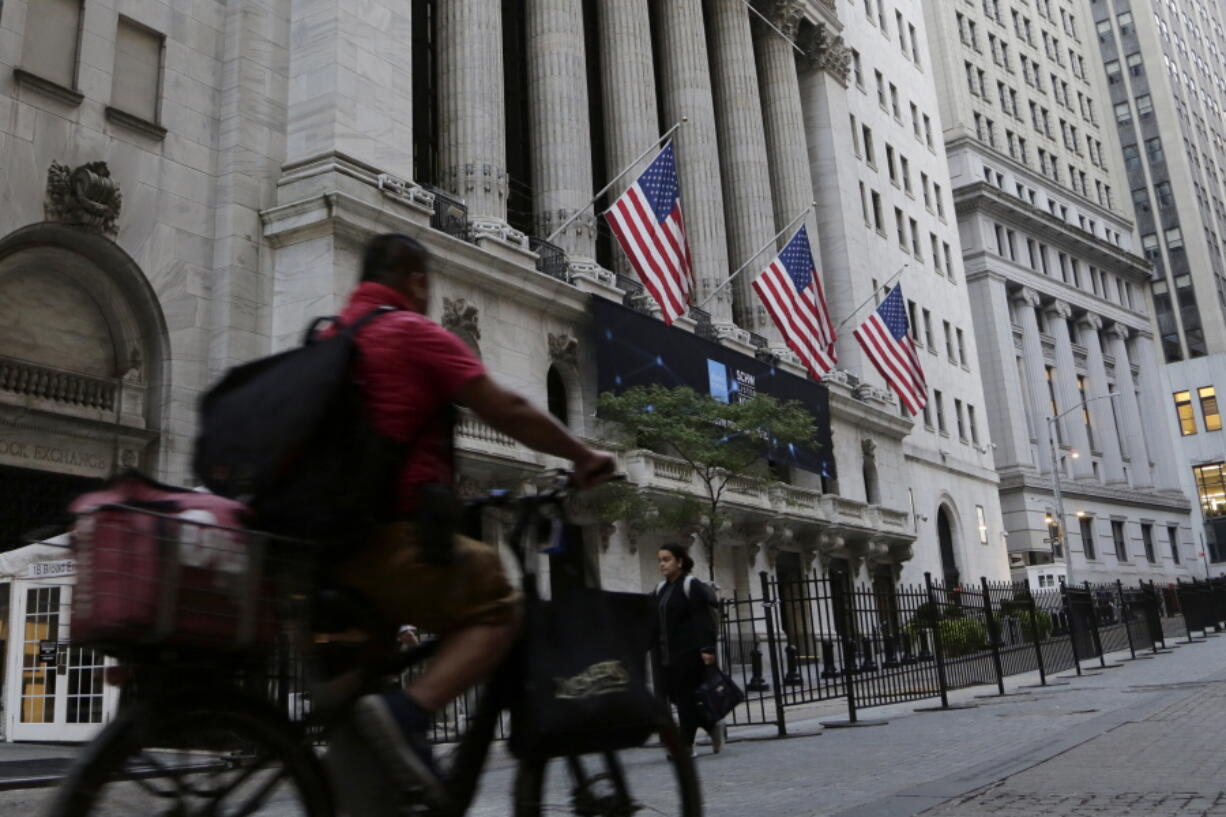 A man bikes past the New York Stock Exchange, Wednesday, Sept. 21, 2022, in New York. Stocks are off to a modestly higher start on Wall Street ahead of a widely expected interest rate increase by the Federal Reserve. The S&P 500 was up half a percent in the early going Wednesday, as was the Dow Jones Industrial Average.