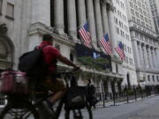 A man bikes past the New York Stock Exchange, Wednesday, Sept. 21, 2022, in New York. Stocks are off to a modestly higher start on Wall Street ahead of a widely expected interest rate increase by the Federal Reserve. The S&P 500 was up half a percent in the early going Wednesday, as was the Dow Jones Industrial Average.