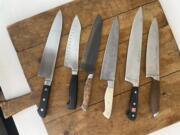 This July 2022 image shows a variety of kitchen knives. Many professionals will say you can perform virtually any kitchen task skillfully with either a chef's knife or a paring knife. Adding other knives to your arsenal is appealing and can be useful but isn't strictly necessary.