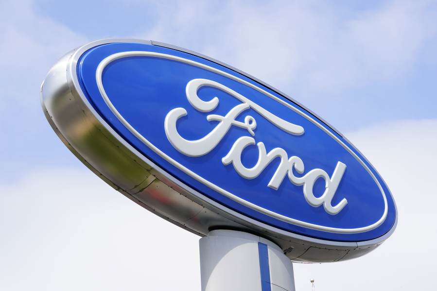 A Ford sign is shown at a dealership in Springfield, Pa., Tuesday, April 26, 2022.  Ford is recalling more than 277,000 pickup trucks and cars in the U.S., Wednesday, Aug. 31,  because the rear view camera lens can get cloudy and reduce visibility for the driver.