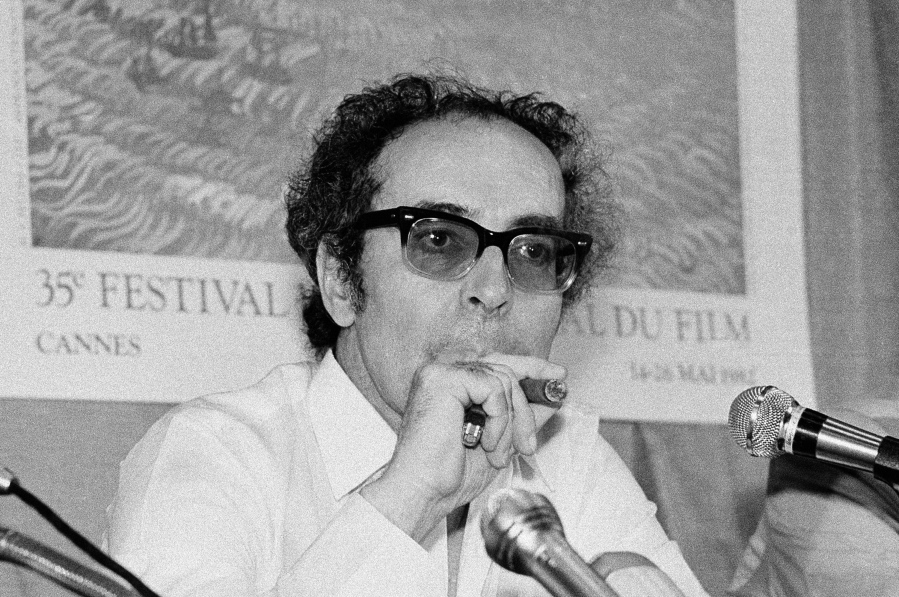 FILE - Film director Jean-Luc Godard smokes at Cannes festival, France on May 25, 1982. Director Jean-Luc Godard, an icon of French New Wave film who revolutionized popular 1960s cinema, has died, according to French media. He was 91. Born into a wealthy French-Swiss family on Dec.