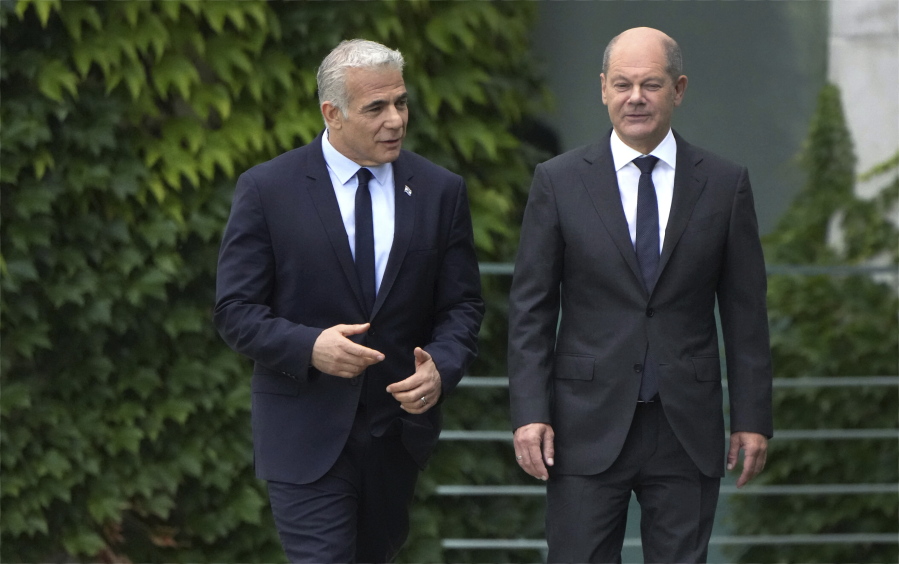 German Chancellor Olaf Scholz, right, and Israeli Prime Minister Yair Lapid, left, arrive for a joint press conference as part of a meeting at the chancellery in Berlin, Germany, Monday, Sept. 12, 2022.