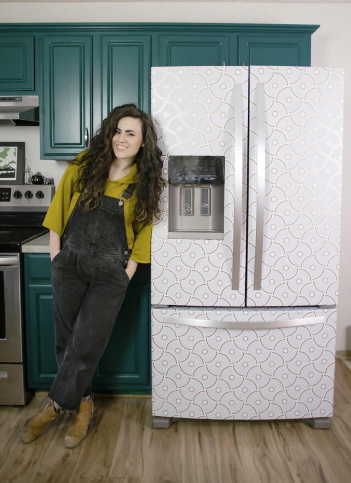 Designer Liz Morrow stands next to her refrigerator covered with a stylish patterned Tempaper removable paper at her home in Tacoma.