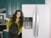 Designer Liz Morrow stands next to her refrigerator covered with a stylish patterned Tempaper removable paper at her home in Tacoma.