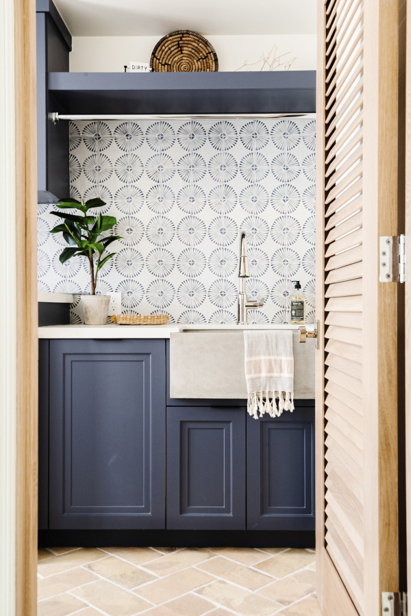 This image provided by Hillary Stamm shows a laundry room. Laundry rooms no longer need to be hidden. Hillary Stamm of HMS Interior Design in El Segundo, California, says: "This is a space you aren't in for hours (let's hope!) so have some fun. A textured tile or an intricate design with a splash of color can work wonders here.".