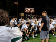 Coach Sean McDonald talks to his players after Woodland's 22-0 win over Kalama on Thursday, Sept. 1, 2022.