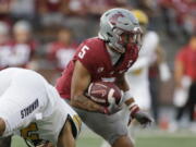 Washington State wide receiver Lincoln Victor avoids a tackle by Idaho linebacker Fa'Avae Fa'Avae during the first half Saturday in Pullman. The Union High grad who was named one of the Cougars six captains for the season caught three passes for 38 yards in Washington State's 24-17 victory.