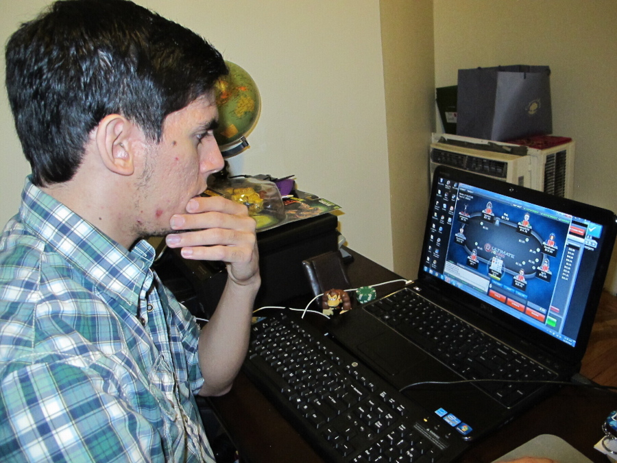 This Nov. 26, 2013 photo shows Jon Hernandez of Roselle Park N.J. playing a game of Internet poker from his home on the day after it became legal in New Jersey. On Thursday, Sept. 15, 2022, New Jersey lawmakers held a hearing to consider extending authorization for the state's highly successful online gambling industry for another decade, through 2033.