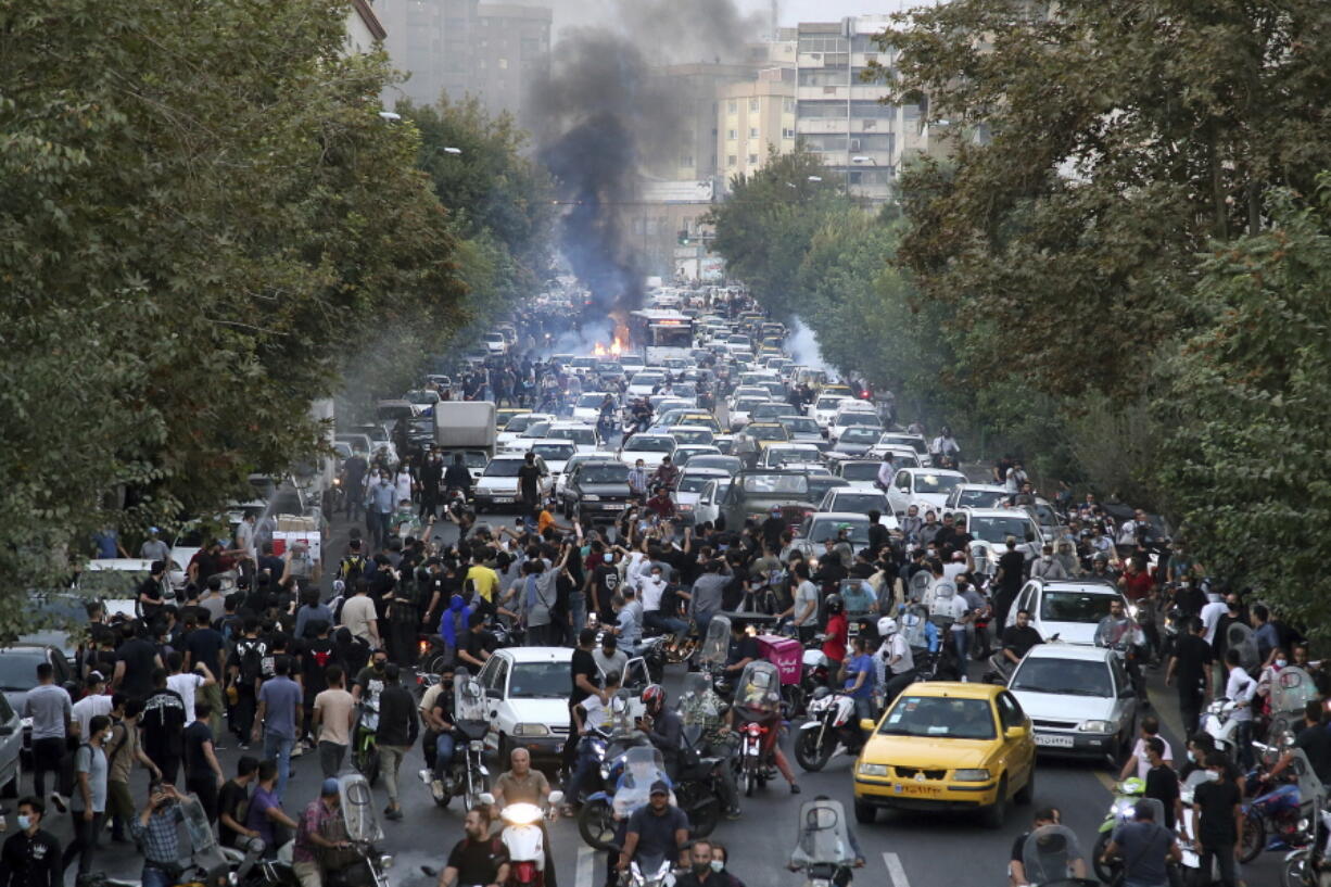 FILE - In this photo taken by an individual not employed by the Associated Press and obtained by the AP outside Iran, protesters chant slogans during a protest over the death of a woman who was detained by the morality police, in downtown Tehran, Iran, Sept. 21, 2022. Iran's Foreign Ministry said Sunday, Sept. 25, 2022, that it summoned Britain's ambassador to protest what it described as a hostile atmosphere created by London-based Farsi language media outlets. The move comes amid violent unrest in Iran triggered by the death of a young woman in police custody. (AP Photo.