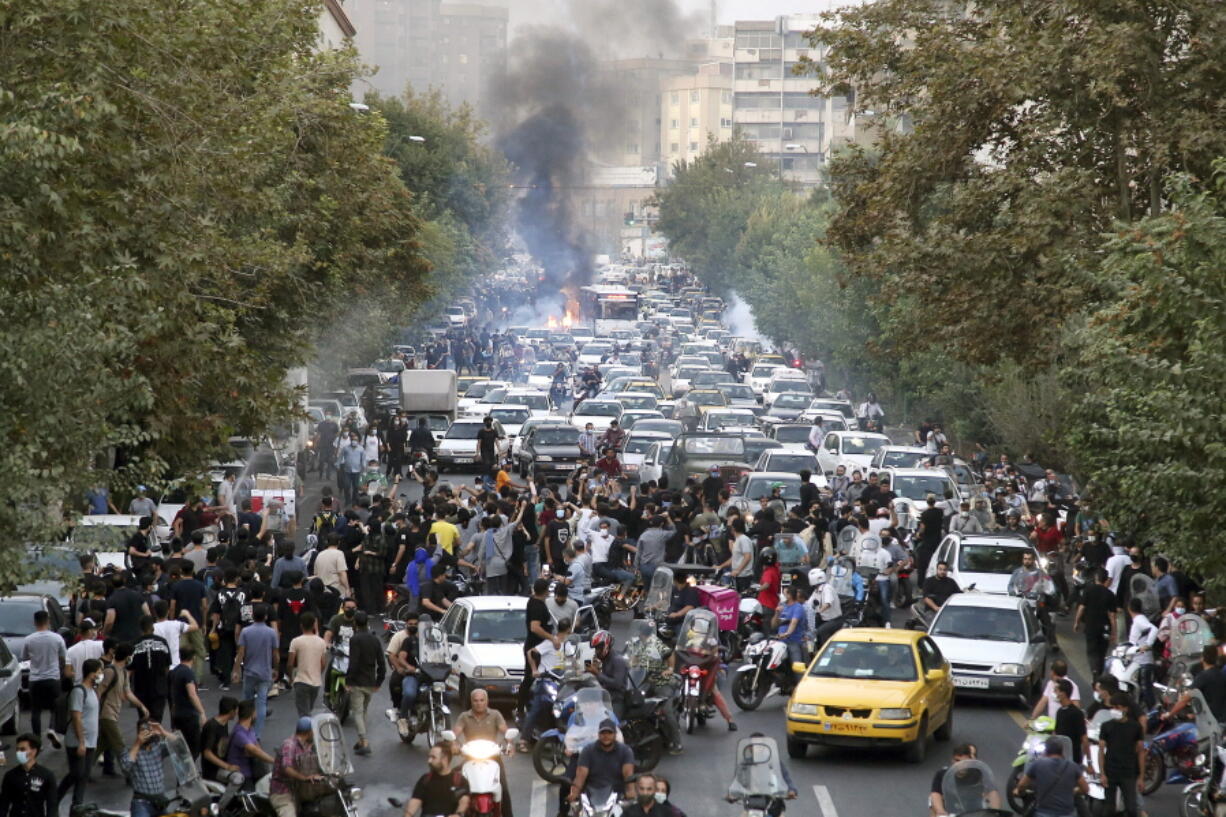 FILE - In this photo taken by an individual not employed by the Associated Press and obtained by the AP outside Iran, protesters chant slogans during a protest over the death of a woman who was detained by the morality police, in downtown Tehran, Iran, Sept. 21, 2022.