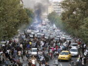 FILE - In this photo taken by an individual not employed by the Associated Press and obtained by the AP outside Iran, protesters chant slogans during a protest over the death of a woman who was detained by the morality police, in downtown Tehran, Iran, Sept. 21, 2022.