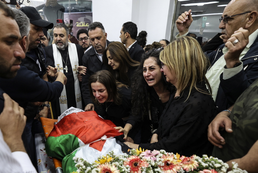 FILE - Colleagues and friends react as the Palestinian flag-draped body of veteran Al-Jazeera journalist Shireen Abu Akleh is brought to the news channel's office in the West Bank city of Ramallah, May 11, 2022. Israel's decision to absolve itself of responsibility for the shooting death of Abu Akleh drew criticism from international media on Thursday, Sept. 8, 2022, marking a further deterioration of relations between the military and reporters covering the conflict. The military said that neither the soldier nor commanders would face any punishment.