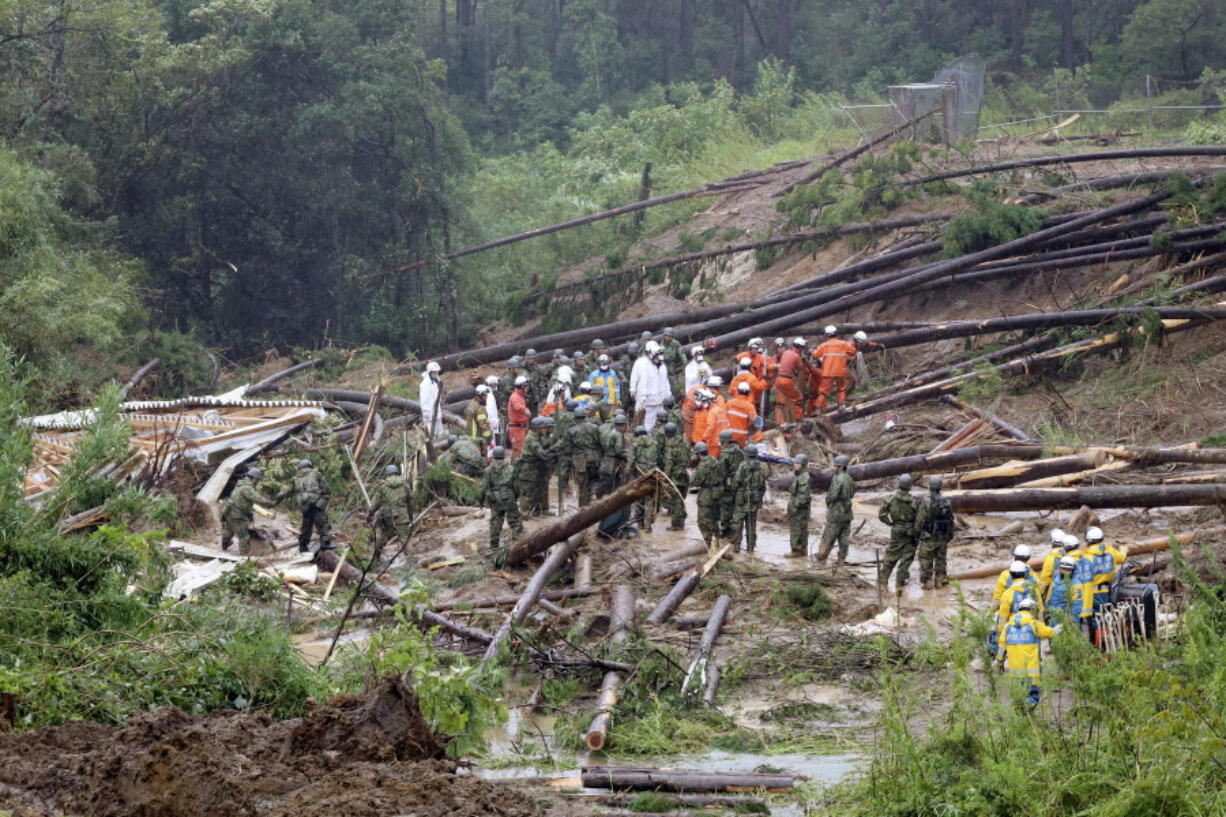 Rescuers conduct a search operation at the site of a landslide in Mimata, Miyazaki Prefecture, southern Japan, Monday Sept. 19, 2022. Powerful Typhoon Nanmadol slammed ashore in southern Japan on Sunday as it pounded the region with strong winds and heavy rain, causing blackouts, paralyzing ground and air transportation and prompting the evacuation of thousands of people.