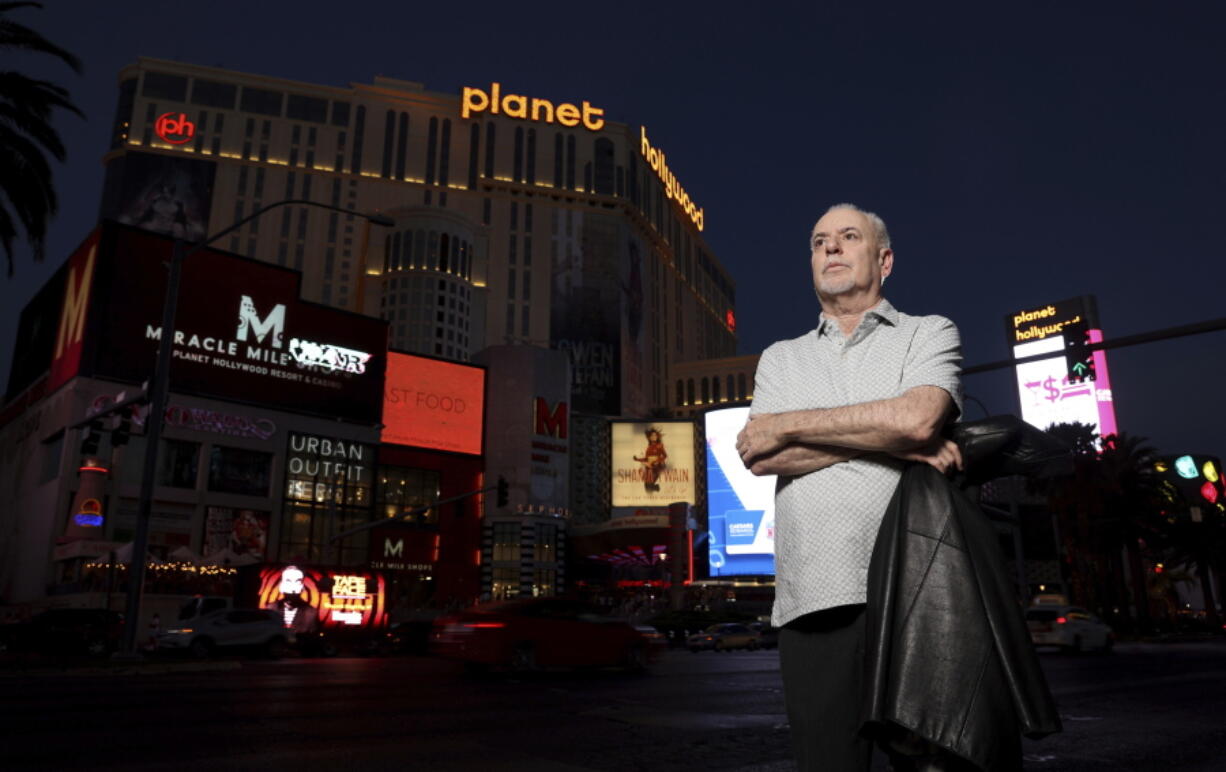 FILE - Jeff German poses on the Strip in Las Vegas, on June 2, 2021. The Las Vegas Review-Journal demanded that authorities don't review slain reporter Jeff German's reporting materials and electronic devices, which were seized by authorities after his death. The materials, which could be used in the prosecution and defense of German's alleged killer, contain confidential sources and unpublished materials that the Review-Journal argued is protected by federal and state law. (K.M.