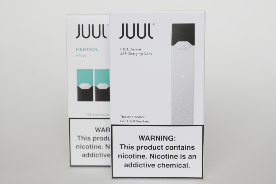 FILE - Packaging for an electronic cigarette and menthol pods from Juul Labs is displayed on Feb. 25, 2020, in Pembroke Pines, Fla. In a deal announced Tuesday, Sept. 6, 2022, electronic cigarette maker Juul Labs will pay nearly $440 million to settle a two-year investigation by 33 states into the marketing of its high-nicotine vaping products, which have long been blamed for sparking a national surge in teen vaping.