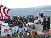 The Kalama Chinooks take the field prior to their non-league game against La Center on Thursday, Sept.