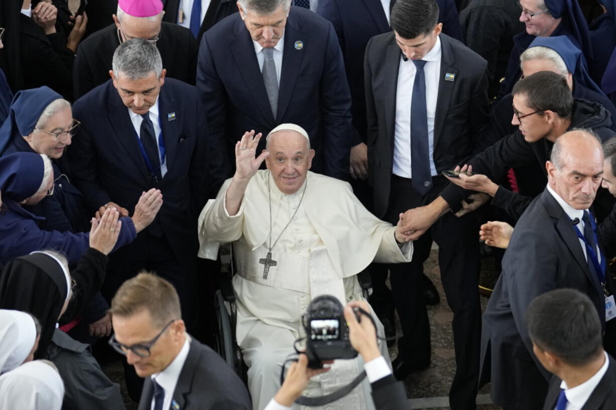 Pope Francis waves at the end of a meeting with priests, religious men and women, seminarians and catechists at the Our Lady Of Perpetual Help Cathedral in Nur-Sultan, Kazakhstan, Thursday, Sept. 15, 2022. Pope Francis is on the third day of his three-day trip to Kazakhstan.