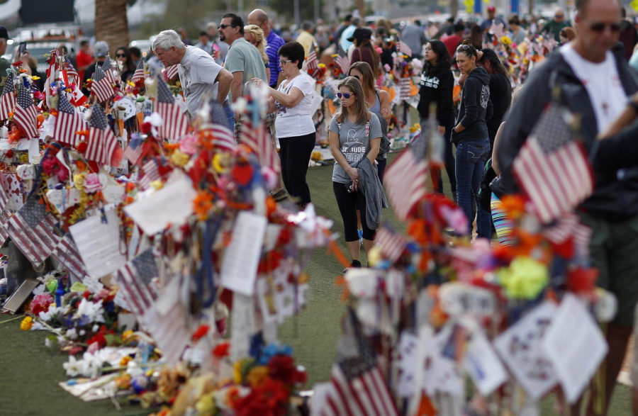 FILE - People visit a makeshift memorial honoring the victims of the Oct. 1, 2017, mass shooting in Las Vegas, on Nov. 12, 2017. Five years after a gunman killed 58 people and wounded hundreds more at a country music festival in Las Vegas, in the deadliest mass shooting in modern U.S. history, the massacre is now part of a horrifying increase in the number of mass slayings with more than 20 victims, according to a database of mass killings maintained by The Associated Press, USA Today and Northeastern University.