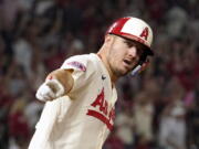 Los Angeles Angels' Mike Trout gestures as he rounds first after hitting a solo home run during the fifth inning of a baseball game against the Seattle Mariners Friday, Sept. 16, 2022, in Anaheim, Calif. (AP Photo/Mark J.