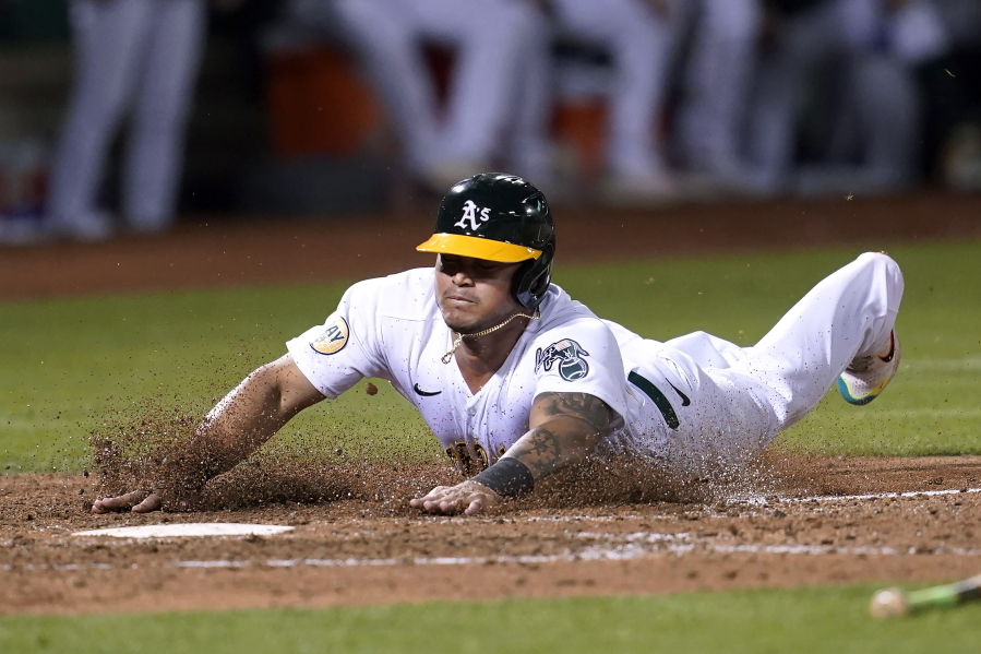 Oakland Athletics' Jordan Diaz scores against the Seattle Mariners during the seventh inning of a baseball game in Oakland, Calif., Wednesday, Sept. 21, 2022.