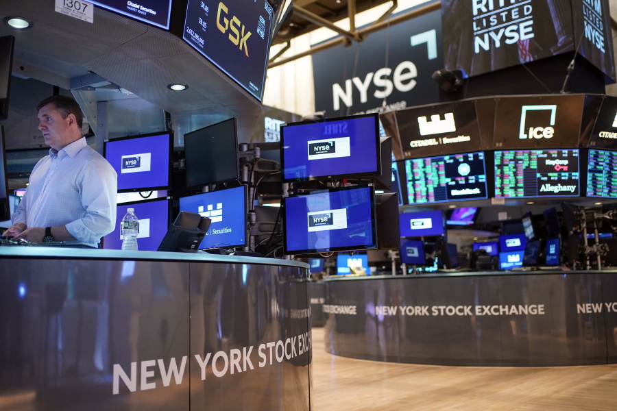 FILE - Traders work on the floor at the New York Stock Exchange in New York, Aug. 10, 2022. Stocks teetered between small gains and losses in morning trading on Wall Street Thursday, Sept. 15, 2022 which left major indexes well in the red for the week.